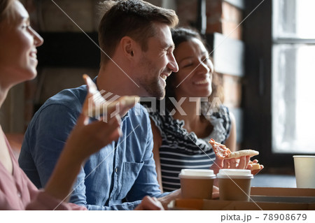 Happy young mixed race best friends communicating in cafe. 78908679