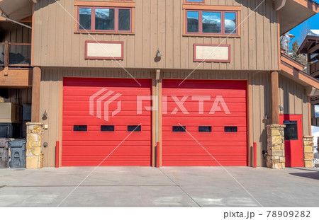 Entrance to the garage with red door of a home in Park City Utah on a sunny day Entrance to the garage with red door of a home in Park City Utah on a sunny day 78909282