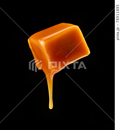 caramel sauce flowing on flying caramel candy caramel sauce flowing on flying caramel candy 78911895
