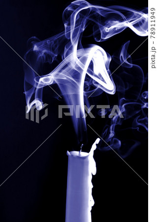 the smoke of an extinguished candle on black background the smoke of an extinguished candle on black background 78911949