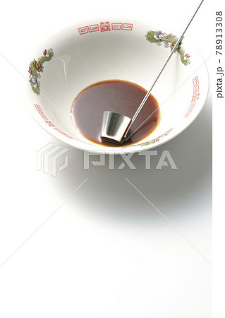 ラーメンどんぶりに醤油ラーメンの元とレードルが入ってる様子を白背景で撮影 78913308