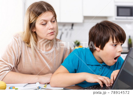Displeased family doing homework 78914572