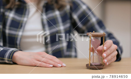 Female Hands Turning Over an Hourglass, Close up Female Hands Turning Over an Hourglass, Close up 78914650