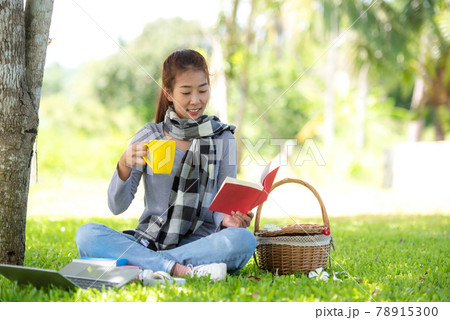 Young people reading book and drinking coffee after working and education on laptop in morning relax Young people reading book and drinking coffee after working and education on laptop in morning relax 78915300