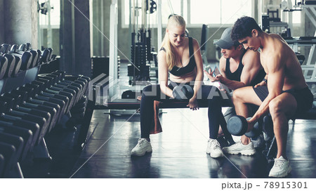 Trainer training exercise with man and woman at the gym for healthy care and body slim.   78915301