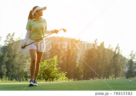 Golfer sport course golf ball fairway. People lifestyle woman relax after swing golf ball on the green. 78915582