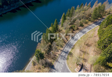 Aerial view of a flight over a reservoir in the Harz Mountains, a German low mountain range, with mountains and forests Aerial view of a flight over a reservoir in the Harz Mountains, a German low mountain range, with mountains and forests 78917654