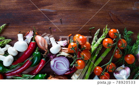 Mushrooms, vegetables, greens on wooden background 78920533