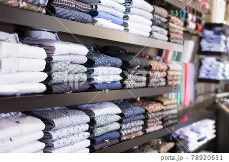 Men shirts displayed on shelves in shop Men shirts displayed on shelves in shop 78920631