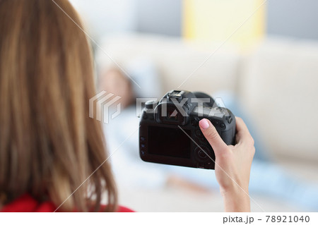 Black modern camera in female hand closeup 78921040
