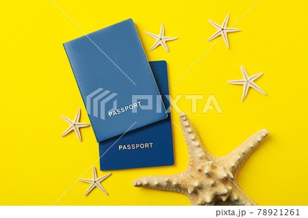 Passports and starfishes on yellow background, top view Passports and starfishes on yellow background, top view 78921261