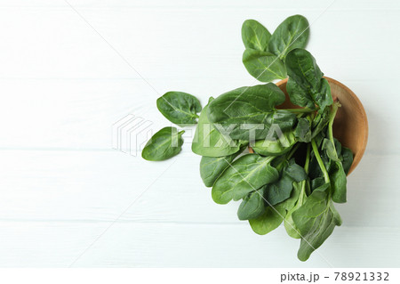 Bowl of spinach on white wooden background 78921332