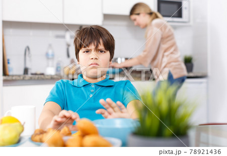 Displeased boy refusing to eat Displeased boy refusing to eat 78921436