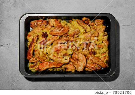 Chicken stripes baked with cheese and onion Chicken stripes baked with cheese and onion 78921706
