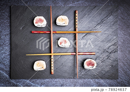 Three in a row made with sushi and chopsticks. Delicious Japanese food Three in a row made with sushi and chopsticks. Delicious Japanese food 78924637