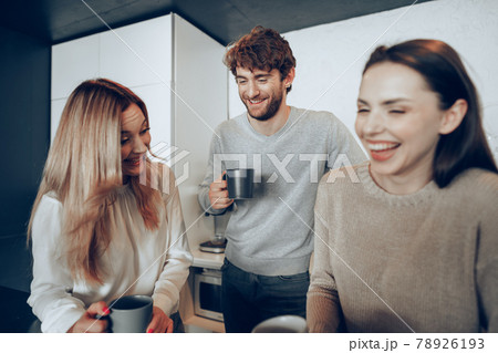 Young businesspeople colleagues having a coffee break in office, drinking and talking Young businesspeople colleagues having a coffee break in office, drinking and talking 78926193