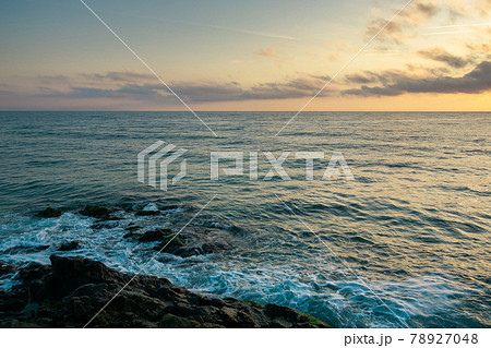 landscape at the sea. beautiful nature background in autumn at sunrise. clouds on the sky above horizon in morning light. water waves crashing coastline. sunny weather. travel in velvet season 78927048