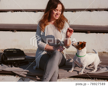 Young woman with her cute Jack Russell Terrier outdoor. Young woman with her cute Jack Russell Terrier outdoor. 78927589