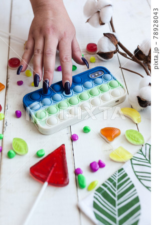 Phone case with pop it on white wooden background 78928043