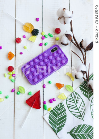Phone case with pop it on white wooden background 78928045