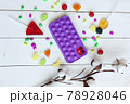 Phone case with pop it on white wooden background 78928046