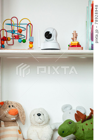 IP camera on the shelf with toys, serving as baby monitor IP camera on the shelf with toys, serving as baby monitor 78928948