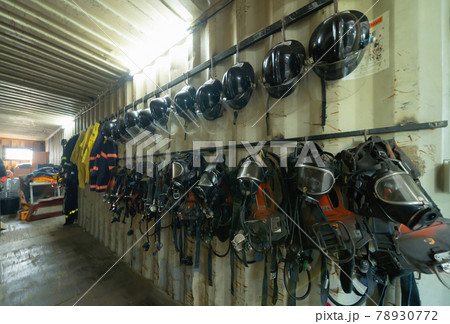 Firefighter or fireman safety protection tools, extinguisher, uniform in a gear storage room, an emergency accident rescue safety and security equipment Firefighter or fireman safety protection tools, extinguisher, uniform in a gear storage room, an emergency accident rescue safety and security equipment 78930772