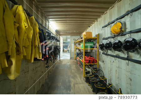 Firefighter or fireman safety protection tools, extinguisher, uniform in a gear storage room, an emergency accident rescue safety and security equipment Firefighter or fireman safety protection tools, extinguisher, uniform in a gear storage room, an emergency accident rescue safety and security equipment 78930773