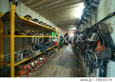 Firefighter or fireman safety protection tools, extinguisher, uniform in a gear storage room, an emergency accident rescue safety and security equipment Firefighter or fireman safety protection tools, extinguisher, uniform in a gear storage room, an emergency accident rescue safety and security equipment 78930774