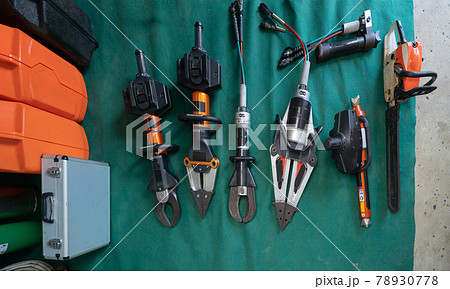 Top view a set of heavy metel firefighter or fireman gear tools, an emergency accident rescue safty and security hardware equipment in machanic workshop. Top view a set of heavy metel firefighter or fireman gear tools, an emergency accident rescue safty and security hardware equipment in machanic workshop. 78930778