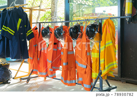 Firefighting or fireman clothes on rack at fire station storage, an emergency accident rescue safety and security equipment 78930782