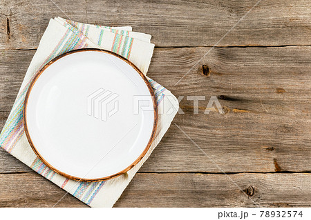 Empty white dish on rustic wooden table 78932574