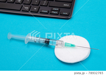 Vaccination or Revaccination Concept - A Medical Syringe on Blue Table 78932765