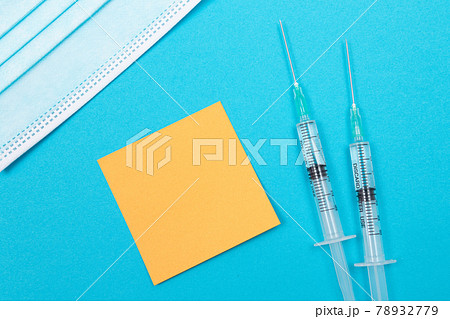 Vaccination or Revaccination Concept - Two Medical Syringe on Blue Table Vaccination or Revaccination Concept - Two Medical Syringe on Blue Table 78932779