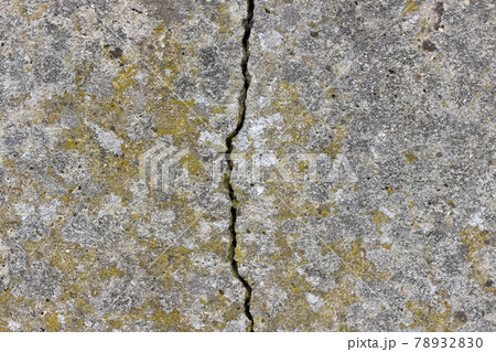 A flat concrete textured surface with a large crack in the middle A flat concrete textured surface with a large crack in the middle 78932830