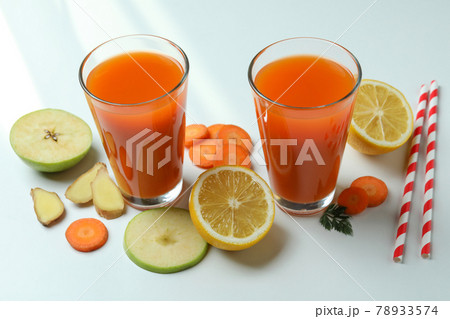 Glasses of juice and ingredients on white background Glasses of juice and ingredients on white background 78933574
