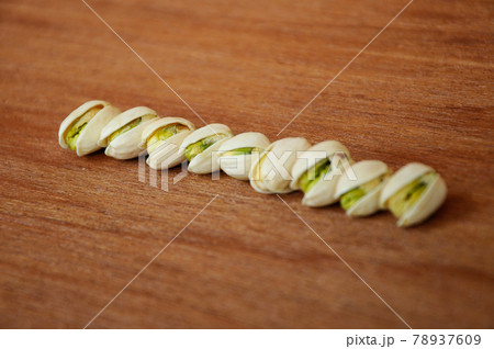 Salted pistachio nuts on wood texture background.    78937609