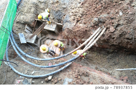 SELANGOR, MALAYSIA -NOVEMBER 03, 2016: Underground utilities trenches. Construction workers digging trenches to lay and install underground utility or services pipes at the construction site. SELANGOR, MALAYSIA -NOVEMBER 03, 2016: Underground utilities trenches. Construction workers digging trenches to lay and install underground utility or services pipes at the construction site. 78937855