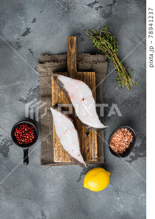 Sliced Halibut fish, with ingredients and rosemary herbs, on gray stone table background, top view flat lay, with copy space for text Sliced Halibut fish, with ingredients and rosemary herbs, on gray stone table background, top view flat lay, with copy space for text 78941237