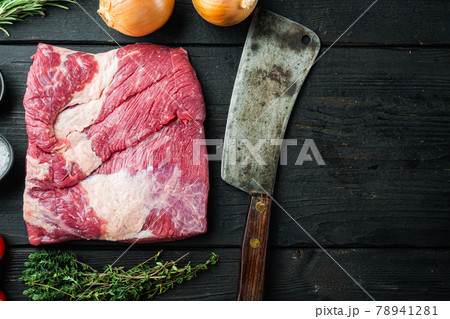 Packer brisket, raw beef brisket meat,with ingredients for smoking making barbecue, pastrami, cure, on black wooden table background, top view flat lay, with copy space for text 78941281