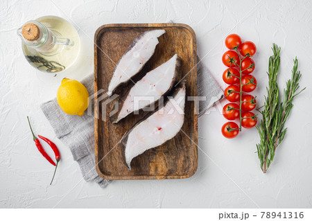 Raw halibut, with ingredients and rosemary herbs, on white stone table background, top view flat lay 78941316