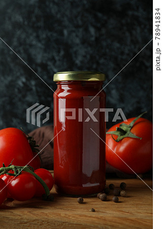 Jar with tomato paste and tomatoes on wooden table Jar with tomato paste and tomatoes on wooden table 78941834