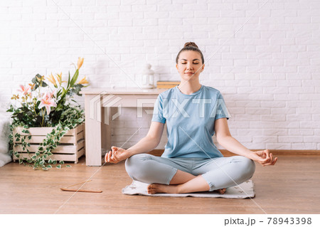 Young girl concentrated in lotus position, yoga at home 78943398