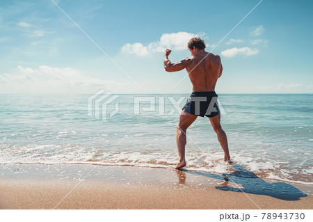 A muay thai or kickboxer training with shadow boxing outdoor at seashore 78943730