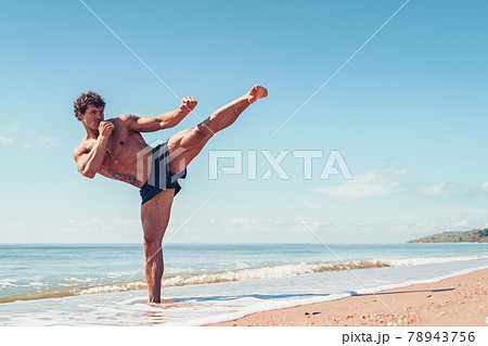 A muay thai or kickboxer training with shadow boxing outdoor at seashore 78943756