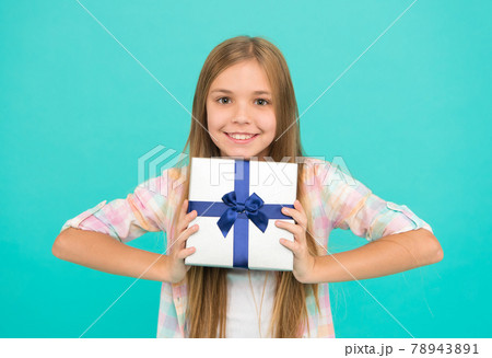 A pleasant gift. Little shopaholic with present wrapped A pleasant gift. Little shopaholic with present wrapped 78943891