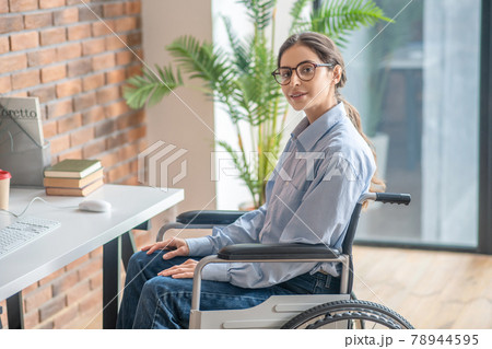 Young dark-haired handicapped woman looking thoughtful 78944595