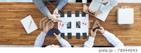 Group of people sitting at table and playing board games top view 78944693