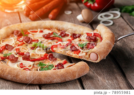Slice of pizza with sausages, smoked chicken, mushrooms, bell peppers, onions Slice of pizza with sausages, smoked chicken, mushrooms, bell peppers, onions 78955981