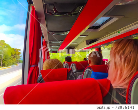 Group of tourist sitting in the bus and looking through the bus windows Group of tourist sitting in the bus and looking through the bus windows 78956141